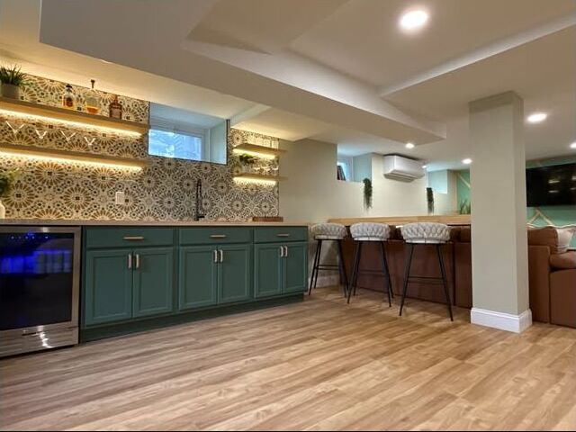 Finished basement renovation with custom bar by EONA Group