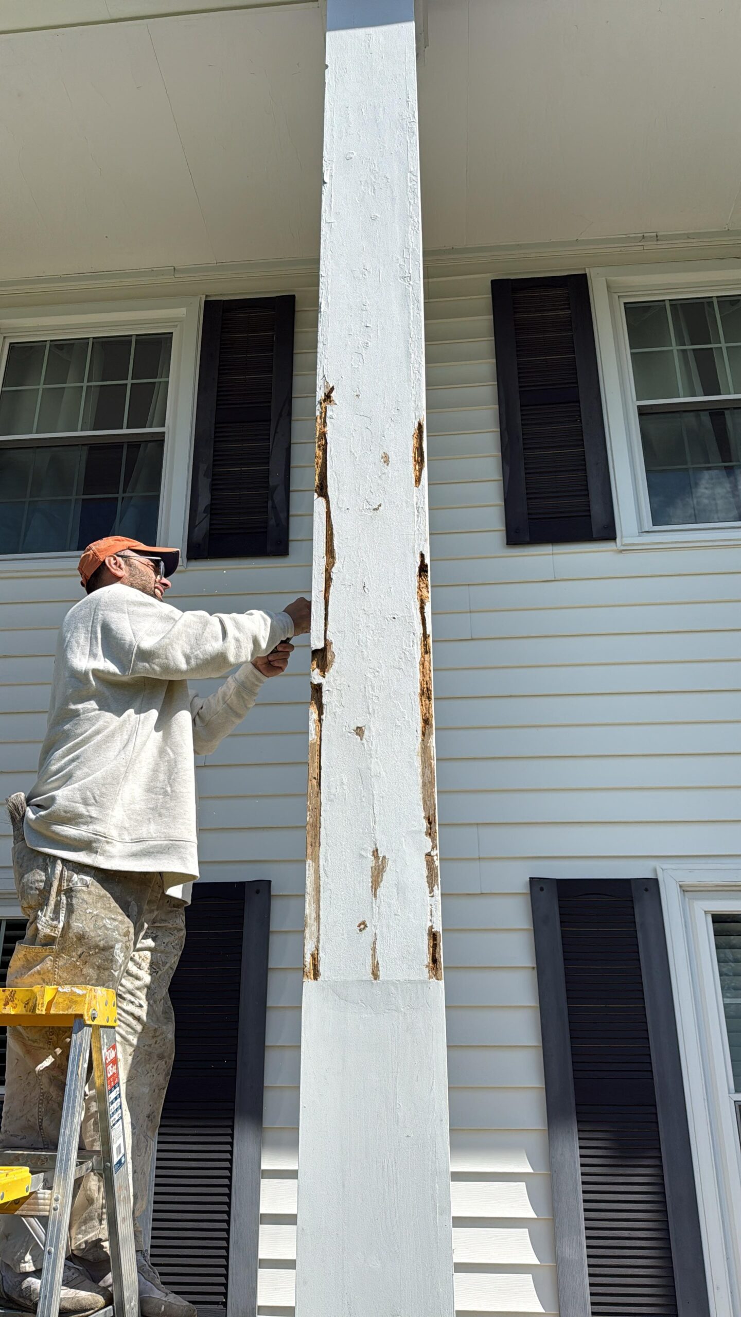 Damaged exterior porch column before restoration