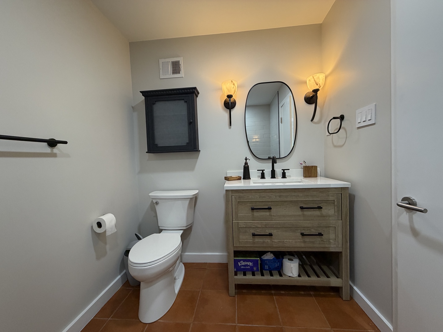 Finished bathroom renovation with new vanity, lighting, and fixtures