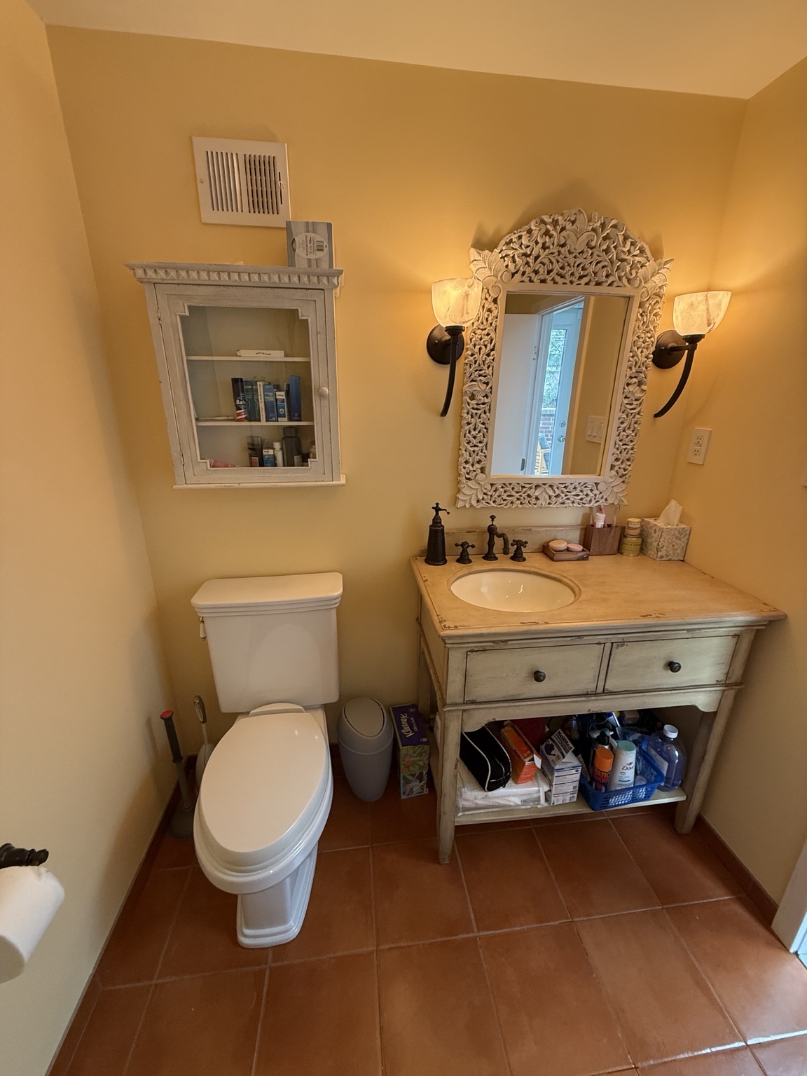 Bathroom before renovation showing the original vanity and toilet